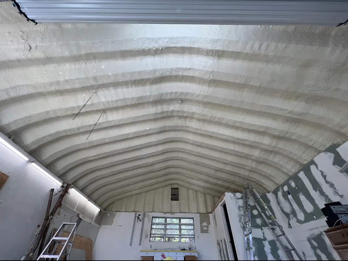 Spray polyurethane foam applied to the underside of a metal roof deck in Demarest